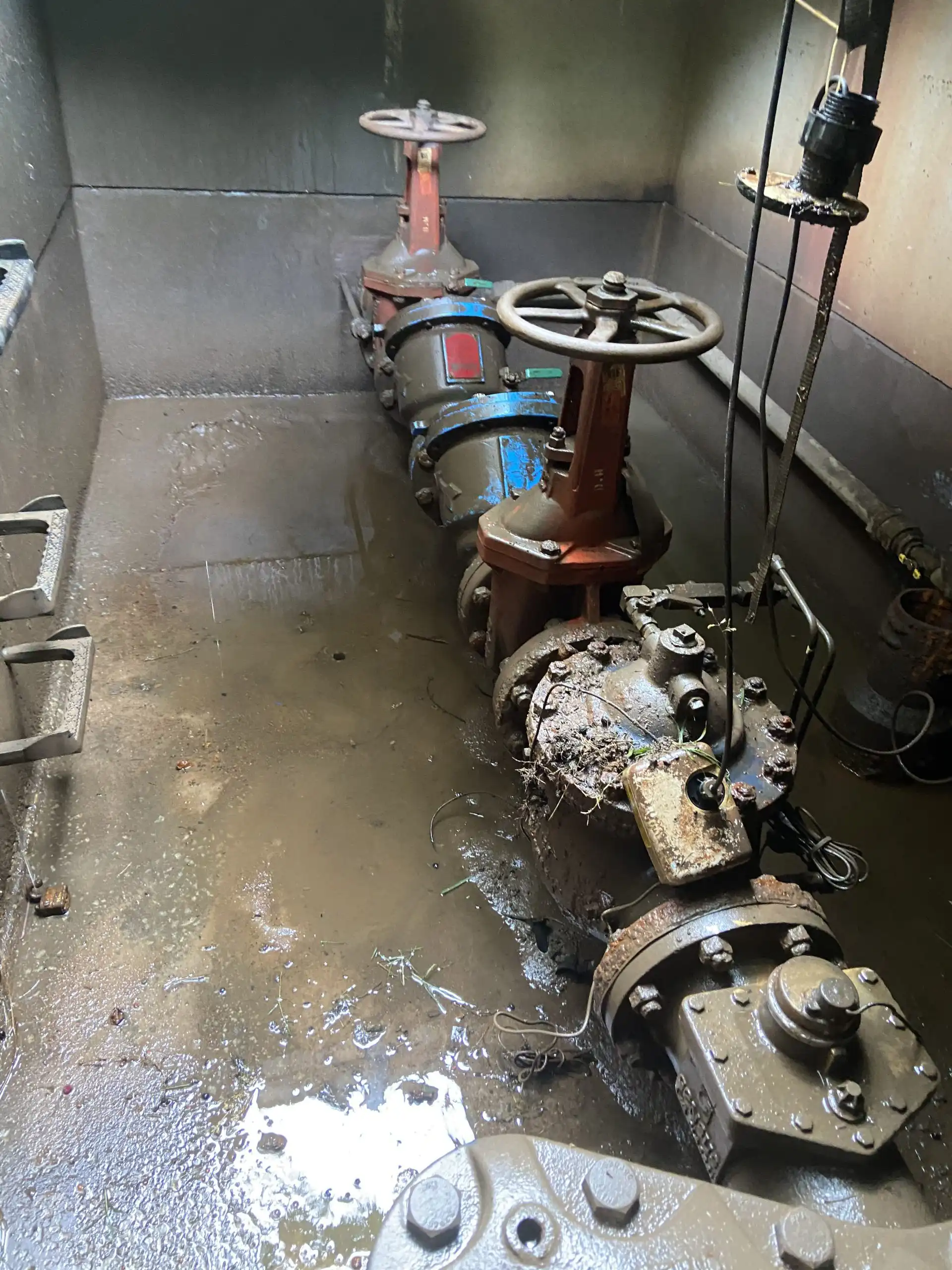 exposed plumbing system in dirt, water