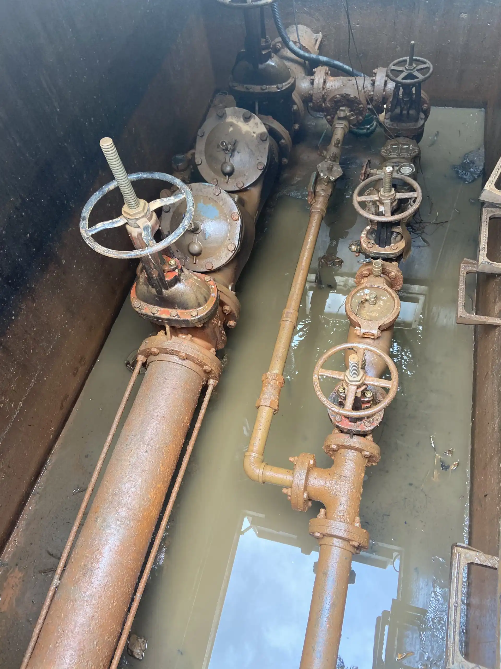 exposed plumbing system in dirt, water