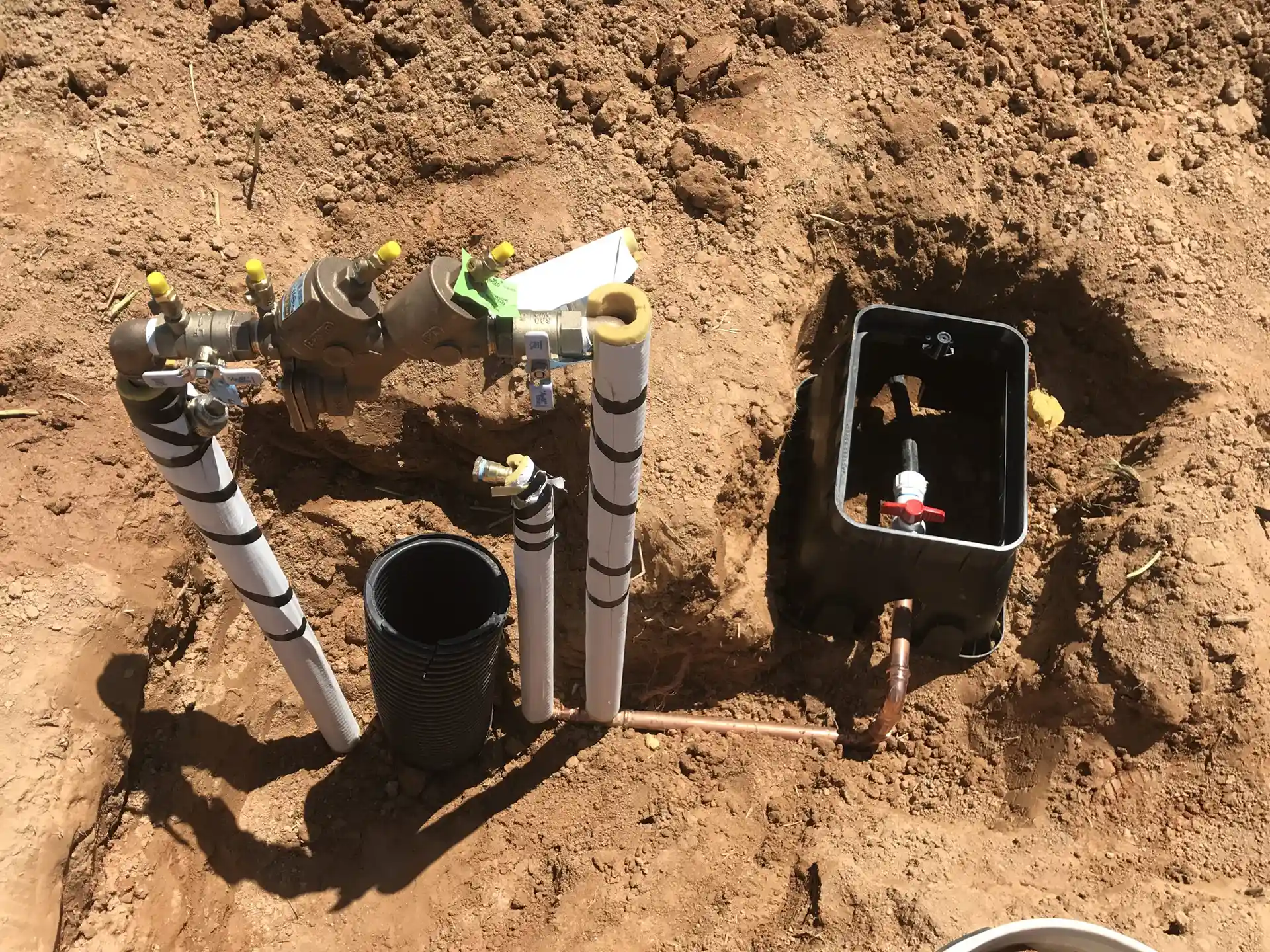 exposed plumbing system in dirt