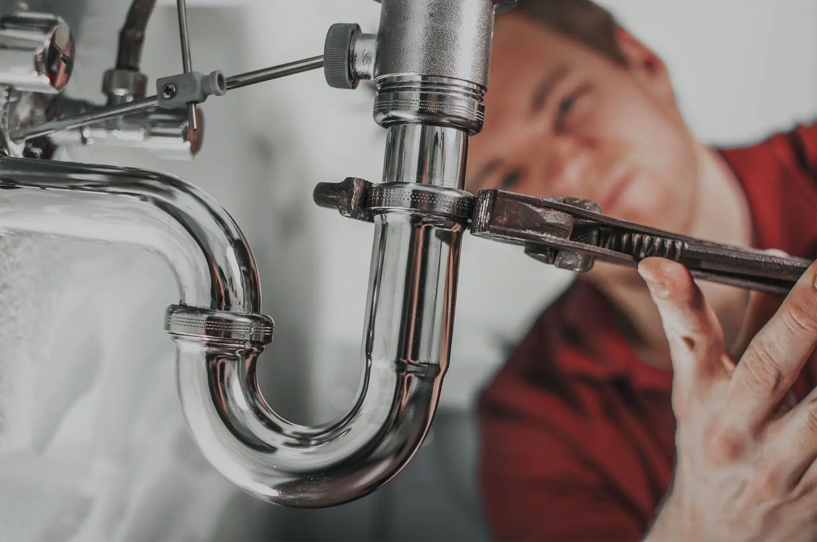 Services 1 plumber tightening sink pipe